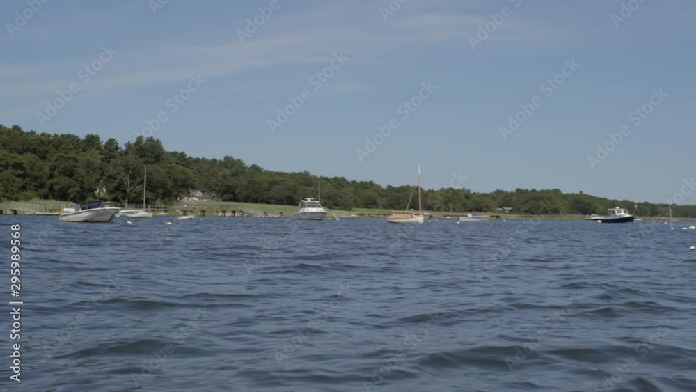Slow pan of boats in a lake in Cape Cod Massachusetts