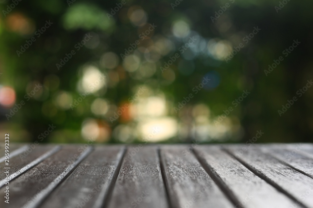 wood table background and out of focus blur bokeh of warm outdoor circle light. abstract copy space for products placement wood table background and out of focus blur bokeh of warm outdoor circle light. abstract copy space for products placement