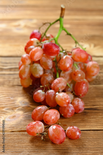 fresh grapes on a wood table vertical composition