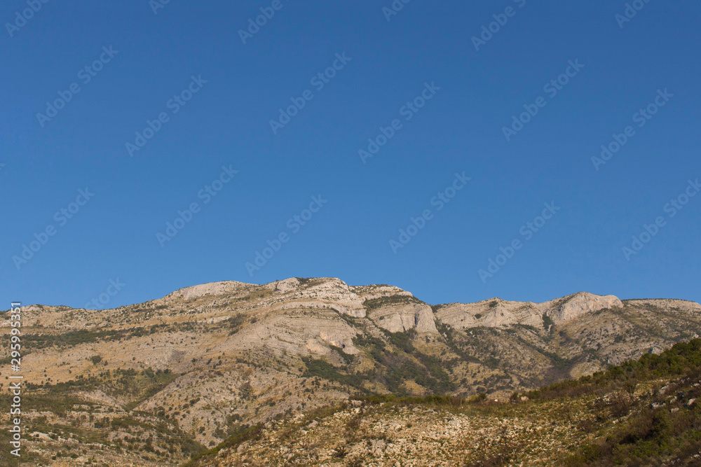 Mountains against the blue sky . Mountains in Montenegro. Selective focus. Mountains against the blue sky . Mountains in Montenegro. Selective focus.