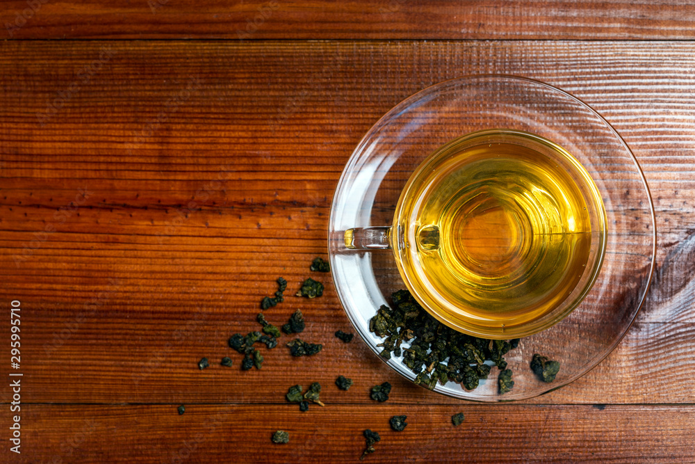 Chinese tea and glass cup on wooden background., top view Chinese tea and glass cup on wooden background., top view