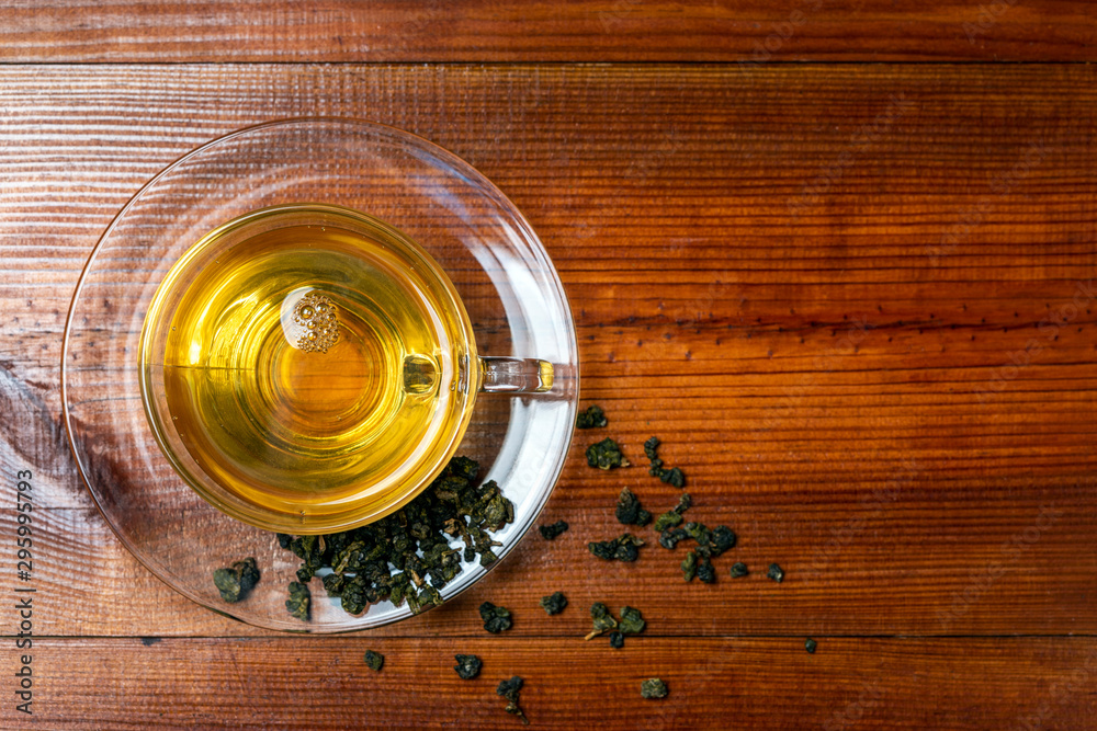 Chinese tea and glass cup on wooden background., top view Chinese tea and glass cup on wooden background., top view