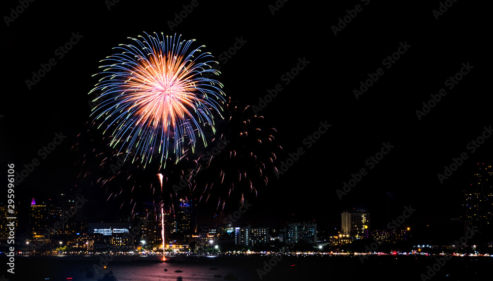 Happy new year fireworks over cityscape at night.holiday celebration festival Happy new year fireworks over cityscape at night.holiday celebration festival