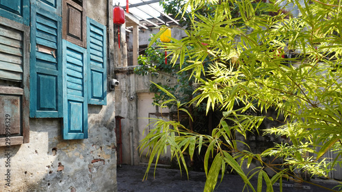 Kwai Chai Hong is a newly restored little back alley in Chinatown, full of cute street art, Malaysia. Bamboo leaves with wooden window.      photo