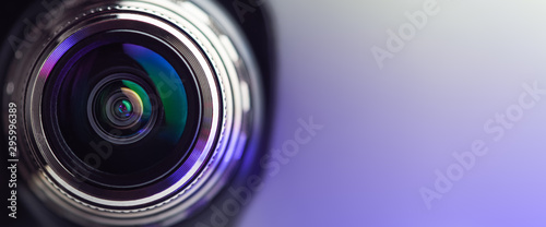 .Banner. The camera lens with purple backlight. Optics. . photo