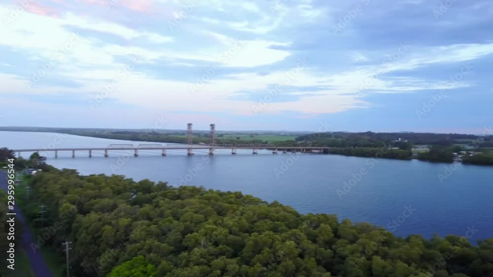 Aerial Drone Panning At Sunset Above Lush Farm Land With Corn Fields And Blue River Reflecting The Orange Sun Aerial Drone Panning At Sunset Above Lush Farm Land With Corn Fields And Blue River Reflecting The Orange Sun