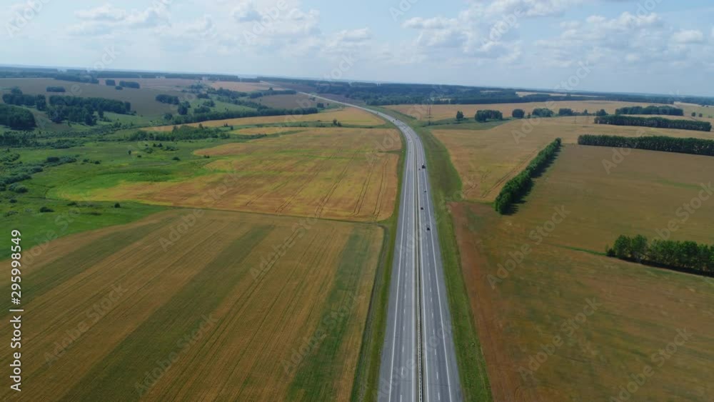 Hyperlapse drone flies over the highway, cars are driving along it Hyperlapse drone flies over the highway, cars are driving along it
