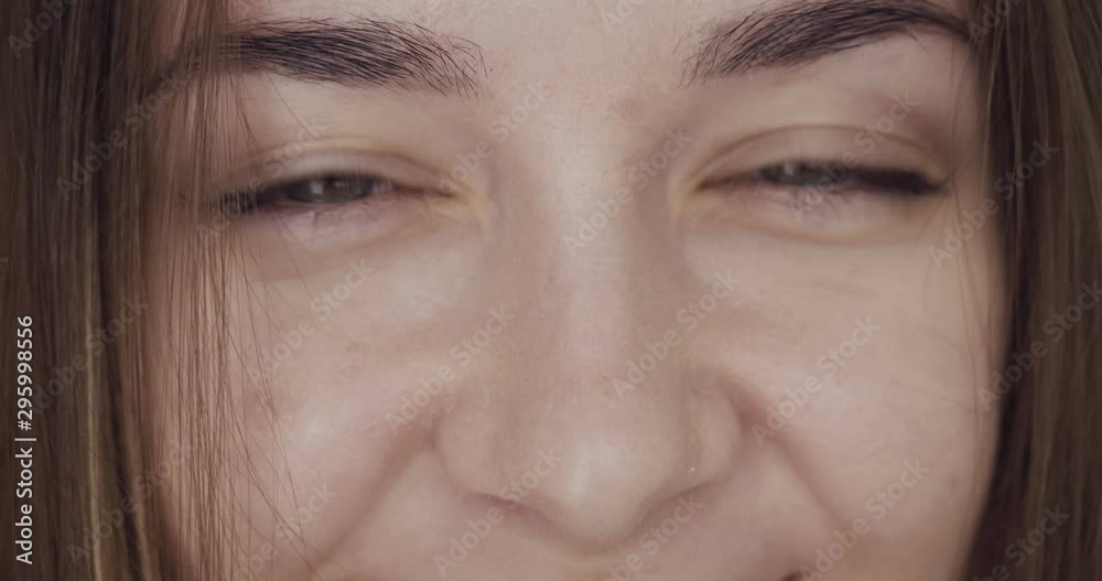 Close-up view on woman's eyes looks and winks on camera. Close-up view on woman's eyes looks and winks on camera.