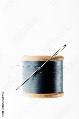 wooden spool of thread and needle