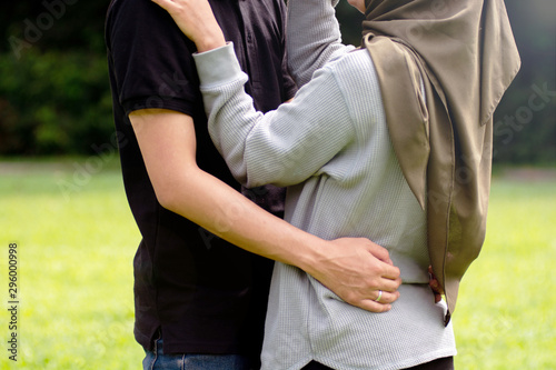 lovely asian Muslim young couple embracing at outdoors