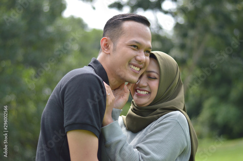 lovely asian Muslim young couple embracing at outdoors
