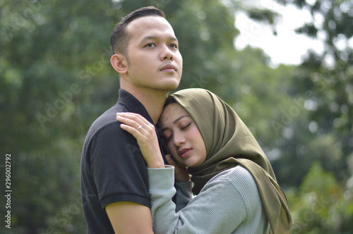 lovely asian Muslim young couple embracing at outdoors