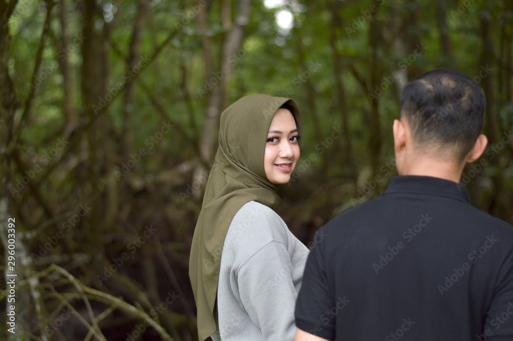 Happy young muslim couple on tropical forest with mangrove Happy young muslim couple on tropical forest with mangrove