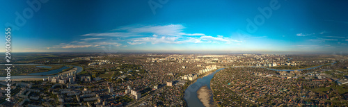 Panorama view over the western outskirts of the city of Krasnodar and the winding Kuban River at the end of an autumn day before sunset