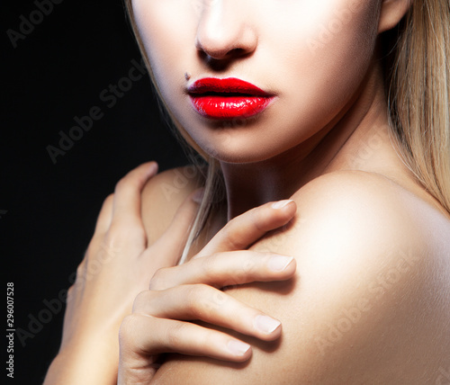 Partial beauty portrait of young woman  red lips make-up  perfect skin  hands near shoulders