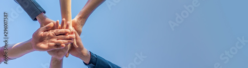 Professional teamwork of business people, woman and man put their hands and holding collaboration together on teamwork expression with copy space for text banner.