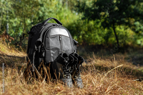 Camping backpack and boots on a background of summer nature. Trekking and camping adventures  hiking  hiking  traveling.