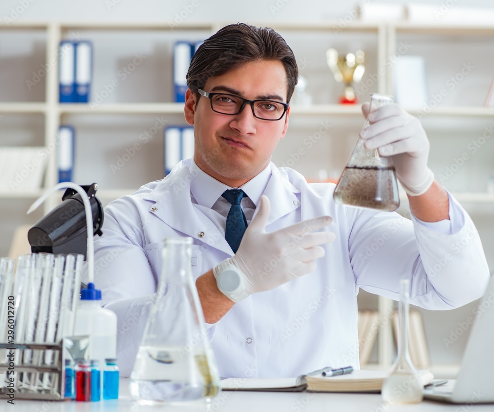 Young researcher scientist doing a water test contamination expe Young researcher scientist doing a water test contamination expe