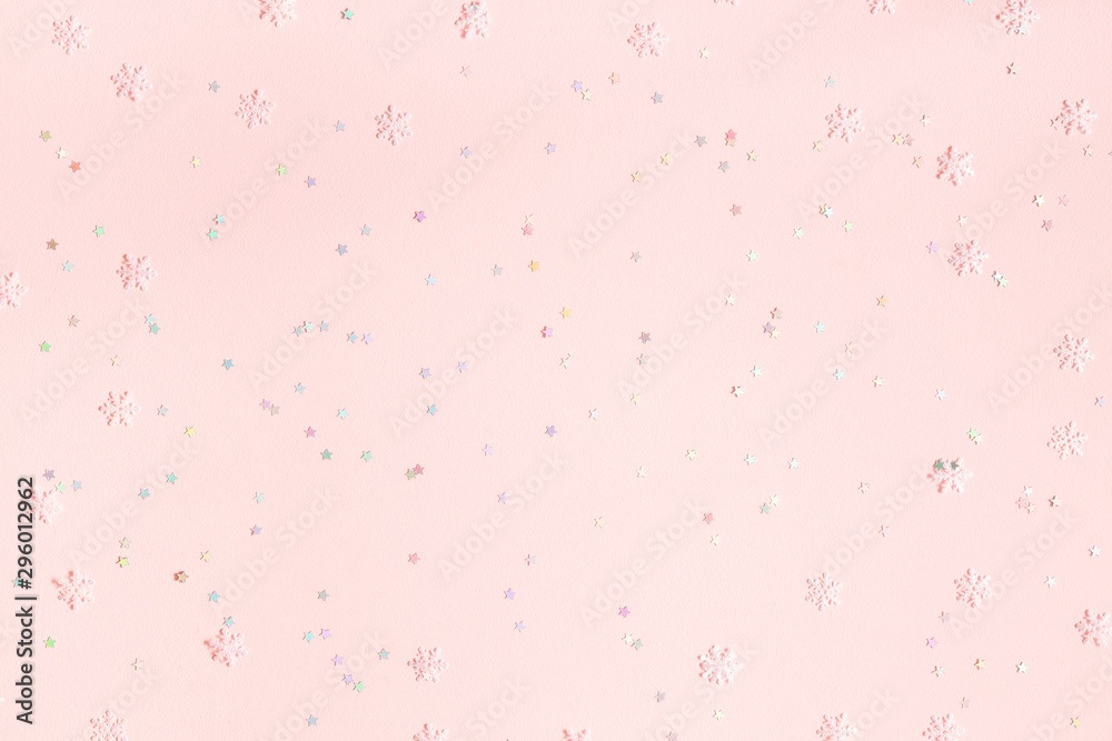 Christmas composition. Confetti, snowflake decorations on pastel pink background. Christmas, winter, new year concept. Flat lay, top view, copy space
