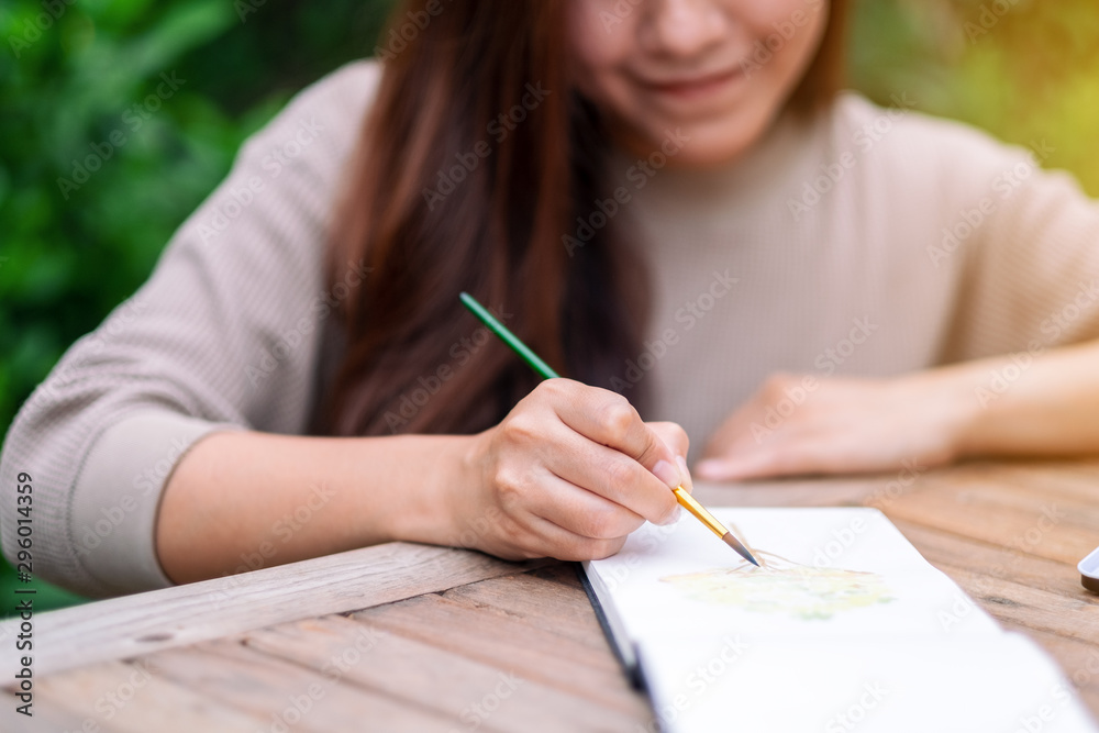 A woman drawing and painting with watercolor A woman drawing and painting with watercolor