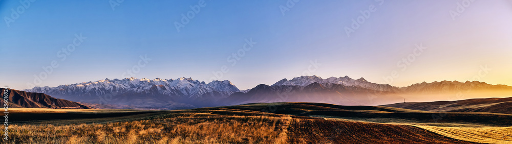 Panorama of a mountain valley in autumn evening. Fairytale sunset over the mountain peaks, amazing nature of the foothills, autumn in the mountains. Travel, tourism. beautiful background picture