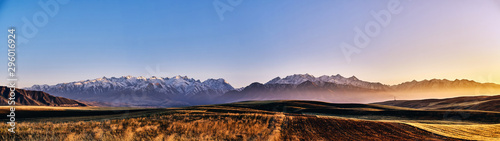 Panorama of a mountain valley in autumn evening. Fairytale sunset over the mountain peaks, amazing nature of the foothills, autumn in the mountains. Travel, tourism. beautiful background picture