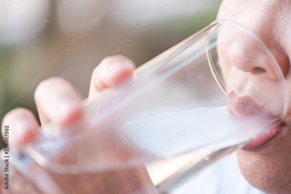 Woman drinking water.Female hand holding glass of water for drink after exercise.Health care food and drink concept.