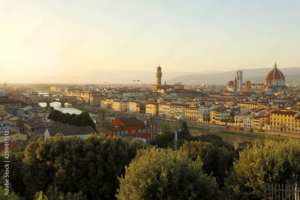 Florence city during golden sunset. Panoramic view of the river Arno with Ponte Vecchio bridge, Palazzo Vecchio palace and Cathedral of Santa Maria del Fiore (Duomo), Florence, Italy.