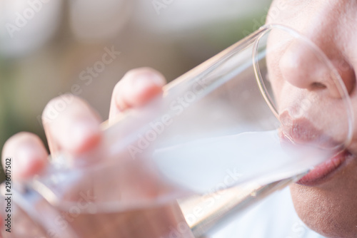 Woman drinking water.Female hand holding glass of water for drink after exercise.Health care food and drink concept.