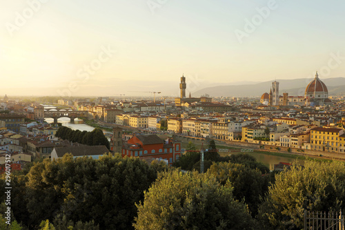 Florence city during golden sunset. Panoramic view of the river Arno with Ponte Vecchio bridge, Palazzo Vecchio palace and Cathedral of Santa Maria del Fiore (Duomo), Florence, Italy.