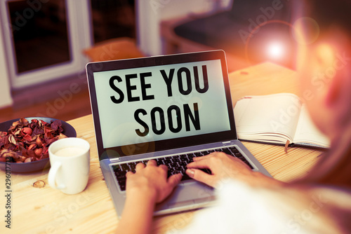 Handwriting text See You Soon. Conceptual photo used for saying goodbye to someone and going to meet again soon woman laptop computer smartphone mug office supplies technological devices