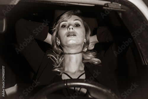 Scene from a detective series. Killer strangles business woman in her car..... photo
