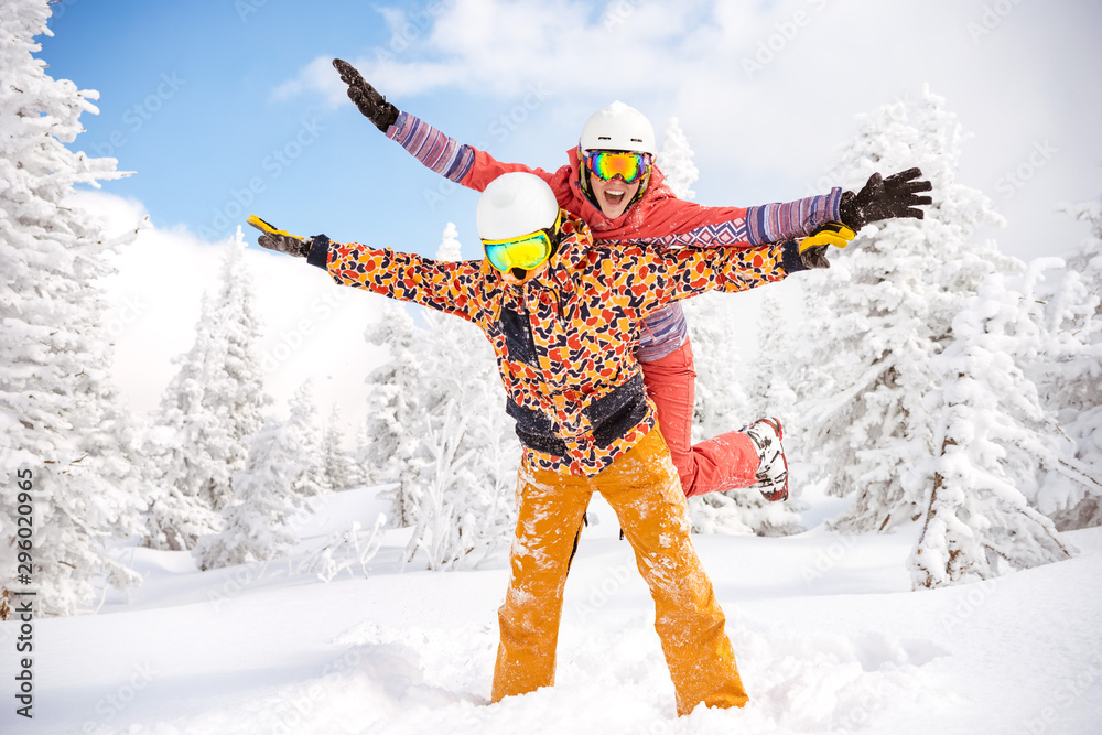 Happy skier and snowboarder having fun