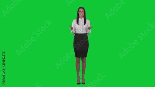 Young elegant formal business woman speaking and gesturing at presentation. Full body isolated on green screen chroma key background. 