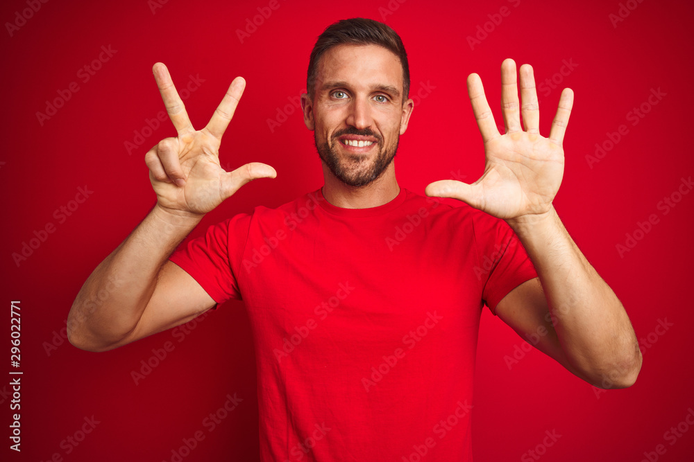 Young handsome man wearing casual t-shirt over red isolated background showing and pointing up with fingers number eight while smiling confident and happy. Young handsome man wearing casual t-shirt over red isolated background showing and pointing up with fingers number eight while smiling confident and happy.