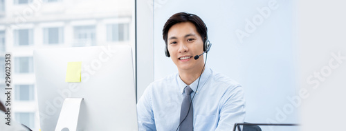 Asian man telemarketing agent  in call center office banner background photo