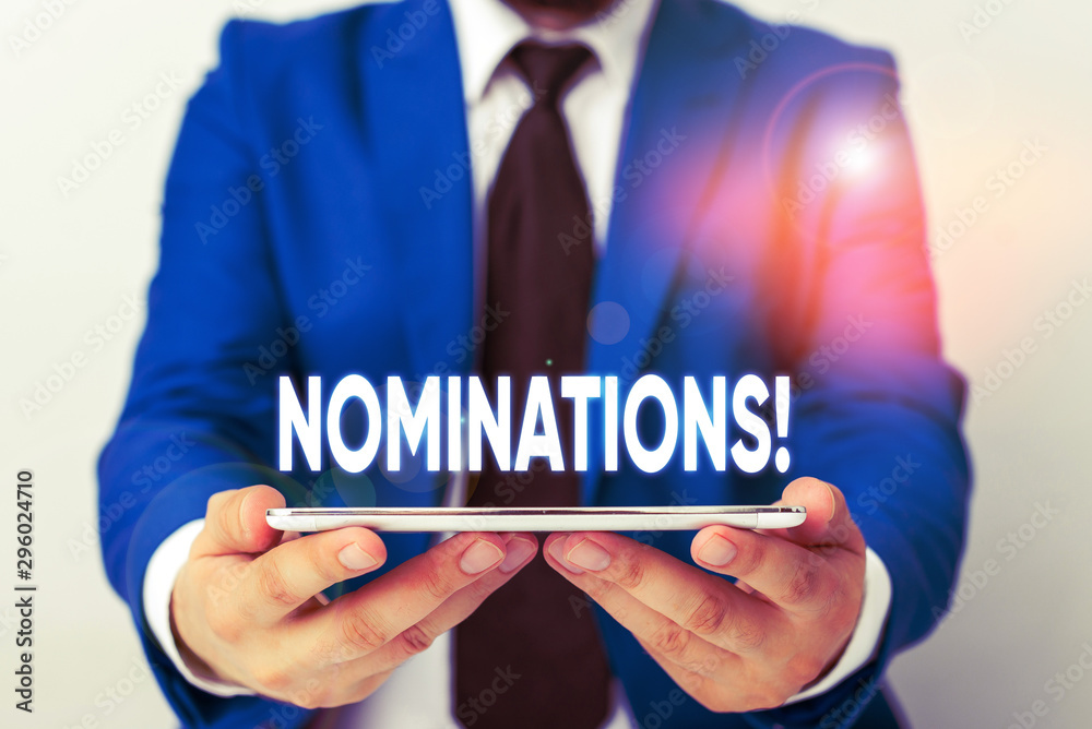 Handwriting text writing Nominations. Conceptual photo action of nominating or state being nominated for prize Businessman in blue suite with a tie holds lap top in hands Handwriting text writing Nominations. Conceptual photo action of nominating or state being nominated for prize Businessman in blue suite with a tie holds lap top in hands
