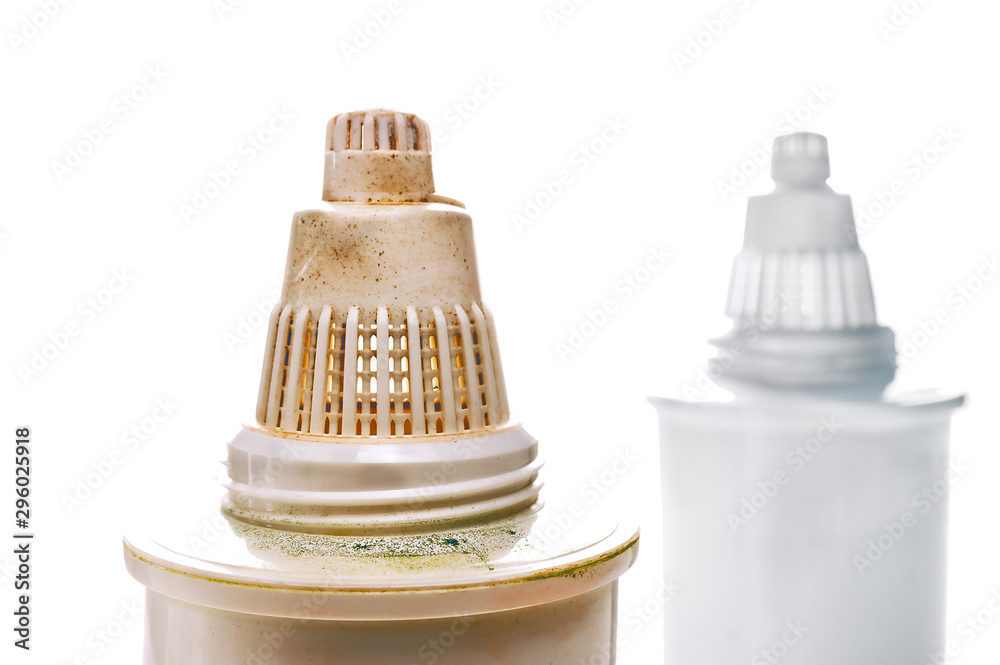 Dirty Used and Blurred Clean New Replacement Pitcher Water Filters on White Background. Used Filter Has Green and Brown Mold Spots. Hygiene, Health Concept. Dirty Used and Blurred Clean New Replacement Pitcher Water Filters on White Background. Used Filter Has Green and Brown Mold Spots. Hygiene, Health Concept.