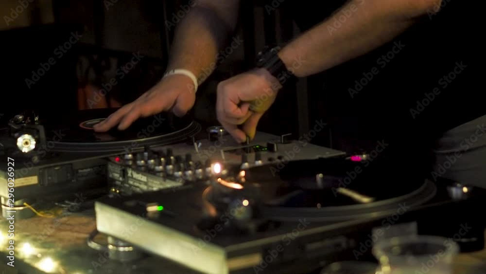 Real DJ at night garden party, scratching, mixing, beat-matching and seeking track. Real DJ at night garden party, scratching, mixing, beat-matching and seeking track.