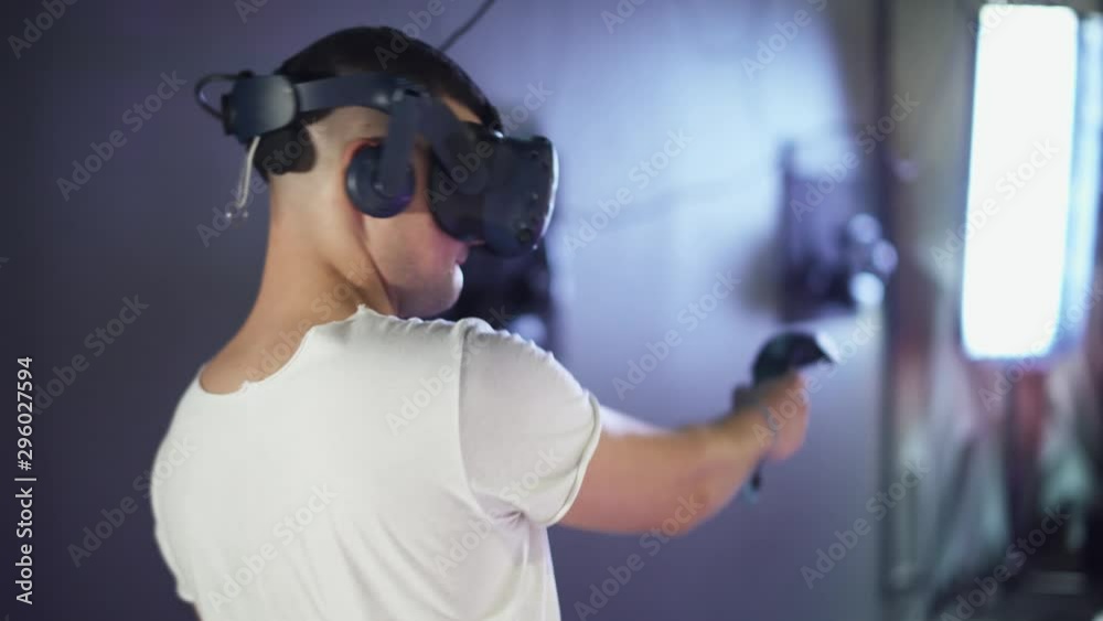 Modern interactive technologies, man in glasses of virtual reality playing a arcade game. Modern interactive technologies, man in glasses of virtual reality playing a arcade game.