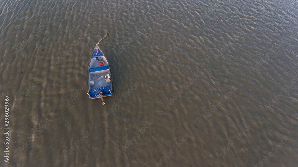 Aerial. An old fishing boat from above, on the Tejo River, in the Samouca Marina. Lisbon. Aerial. An old fishing boat from above, on the Tejo River, in the Samouca Marina. Lisbon.