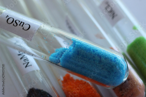 Blue crystals of copper sulfate in test tube. The substance is used in chemistry and in agriculture as an antiseptic and fungicide. photo