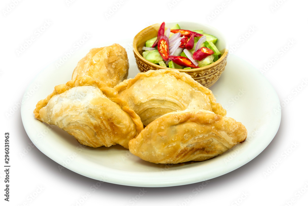 Curry puff pastry isolated on wooden table background with clipping path.