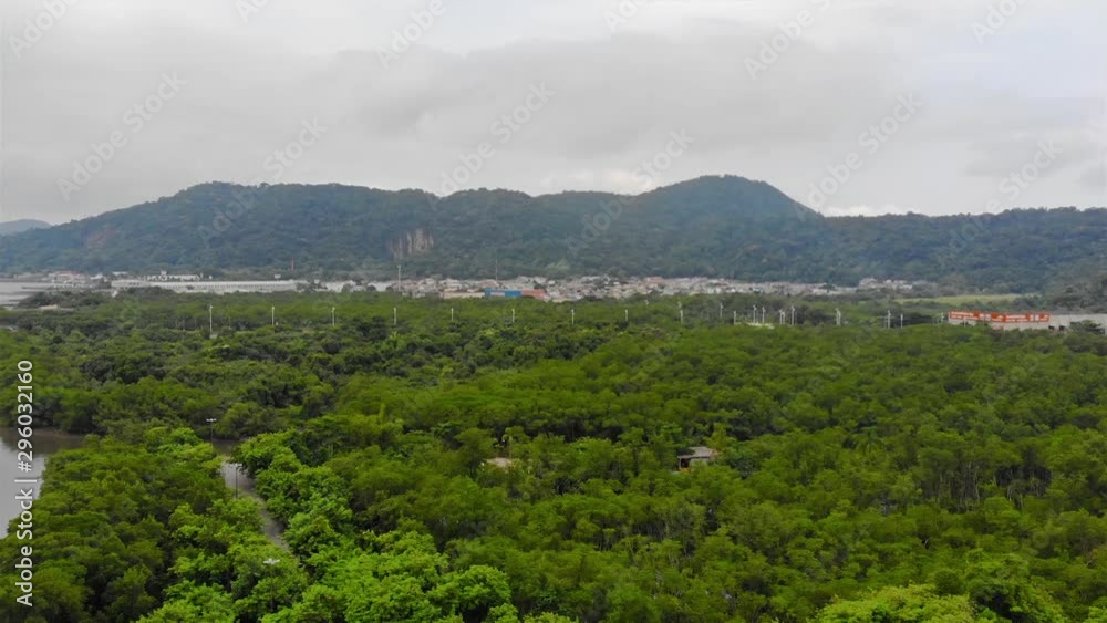 Top Aerial View Of Green Island Full Of Many Trees With Green Mountain Views And Beautiful City - Moving Down Top Aerial View Of Green Island Full Of Many Trees With Green Mountain Views And Beautiful City - Moving Down