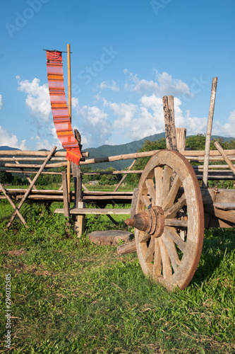 wooden wagon wheel with metal rim in a field  located  in Nan Province,Thailand