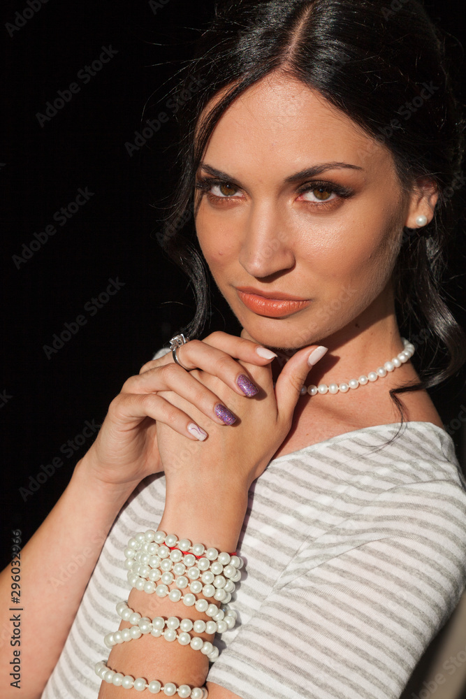 Portrait of a beautiful brunette woman in a striped dress