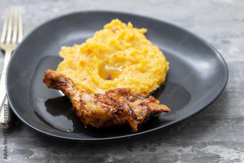 chicken with mashed sweet potato on black dish chicken with mashed sweet potato on black dish