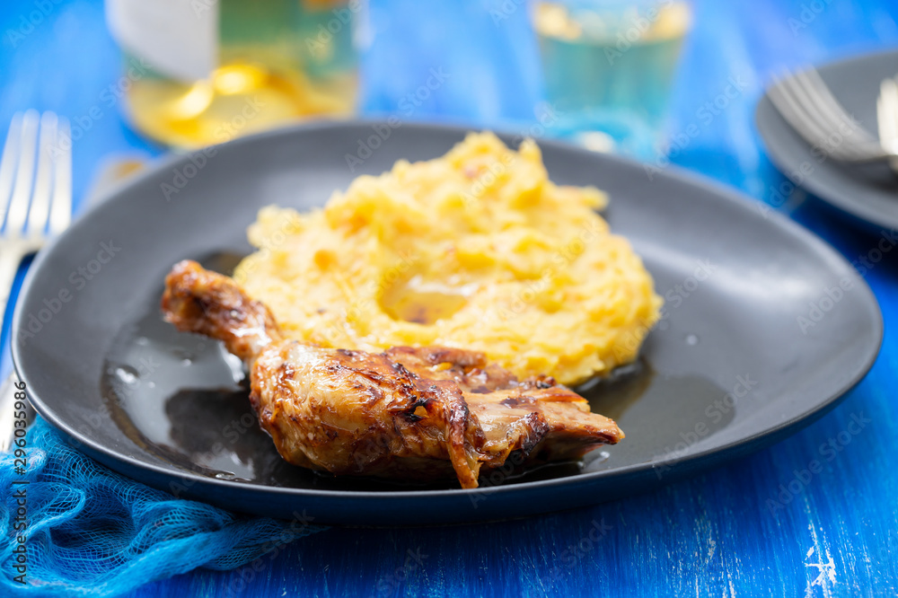 chicken with mashed sweet potato on black dish chicken with mashed sweet potato on black dish