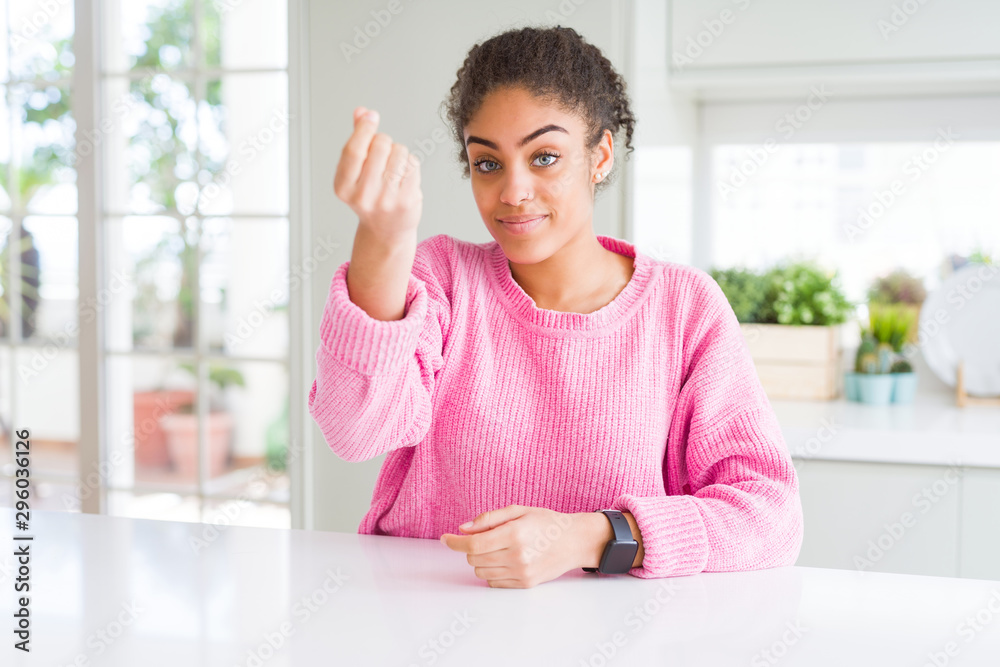 Beautiful african american woman with afro hair wearing casual pink sweater Doing Italian gesture with hand and fingers confident expression Beautiful african american woman with afro hair wearing casual pink sweater Doing Italian gesture with hand and fingers confident expression