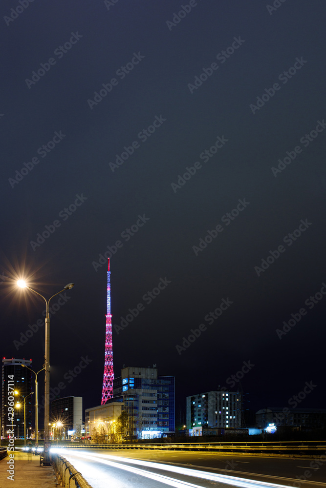 luminous television tower in perm between buildings